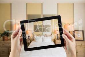 Female Hands Holding Computer Tablet In Room with Photo on Scree