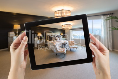 Female Hands Holding Computer Tablet In Room with Photo on Scree