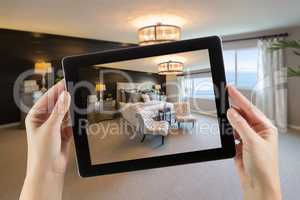 Female Hands Holding Computer Tablet In Room with Photo on Scree