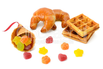 Croissants, waffles and marmalade isolated on white