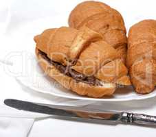 baked croissants with chocolate on a white ceramic plate