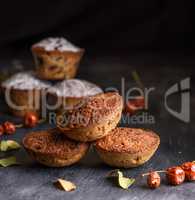 baked round muffins with a raisin black wooden table