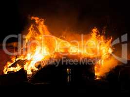 Burning fire flame on wooden house roof