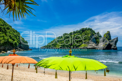 Umbrellas on a Tropical Beach and Islands in the Ocean