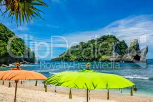 Umbrellas on a Tropical Beach and Islands in the Ocean