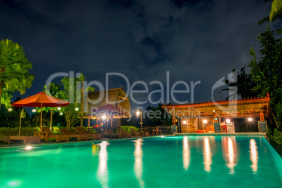 Empty Pool and Bar in the Night Jungle