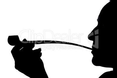 Silhouette of a woman smoking a pipe