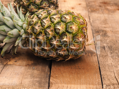 Organic pineapples on rustic wood