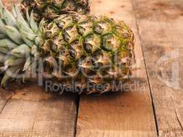 Organic pineapples on rustic wood