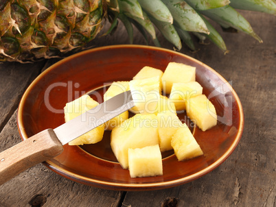 Sweet organic pineapple on wood