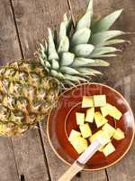 Sweet organic pineapple on wood