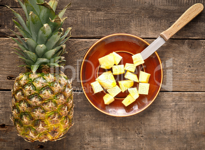 Sweet organic pineapple on wood