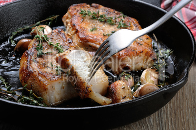 Roasted pork steak in frying pan