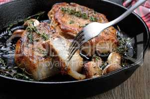 Roasted pork steak in frying pan
