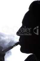 Silhouette of a woman with an electronic cigarette