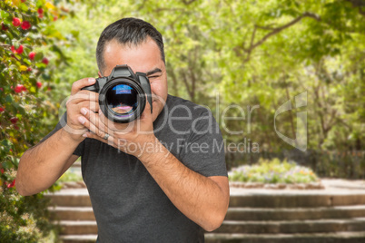 Hispanic Young Male Photographer With DSLR Camera Outdoors