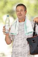 Man with water bottle and sports bag