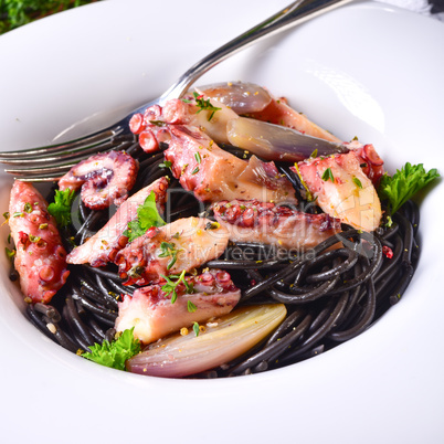 octopus with black spaghetti and garlic sauce