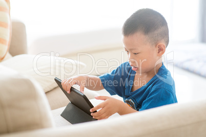 Young child addicted to tablet.