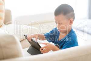 Young child addicted to tablet.