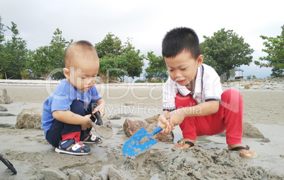 Asian children playing sand