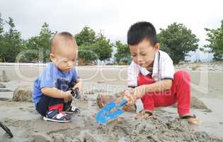 Asian children playing sand