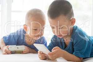 Young children addicted to smart phone.