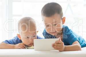 Young boys addicted to smart phone.