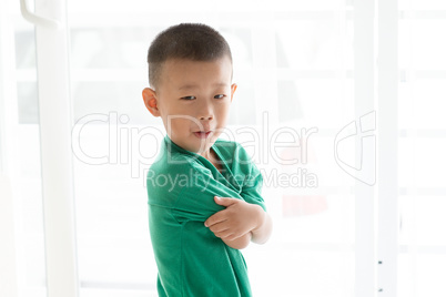 Asian boy grimacing