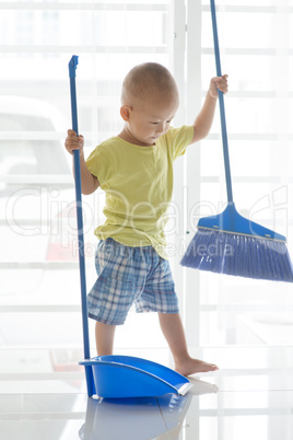 Toddler sweeping floor