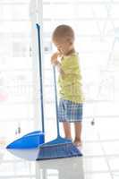 Young kid sweeping floor