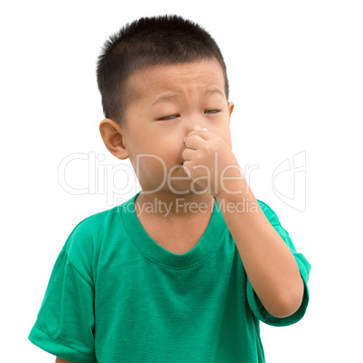 Asian child pinches nose