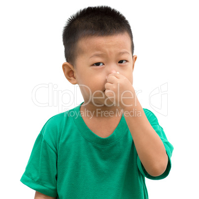 Asian child pinches his nose