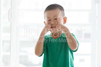 Playful boy pulling face