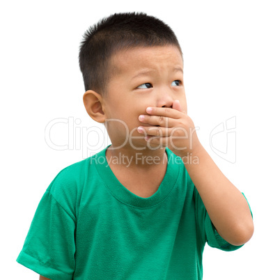Asian child covered mouth looking away