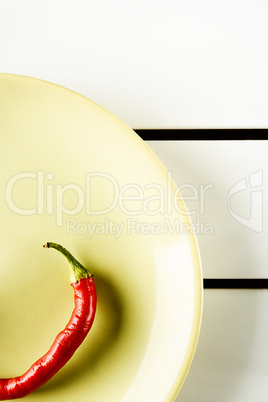 Red hot pepper on green dish.