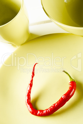 Red hot pepper on green dish.