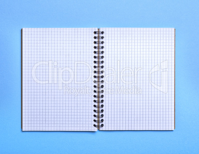 open blank notebook in a box on a blue background