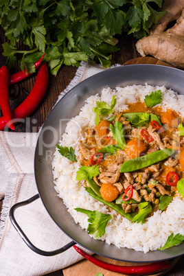 wok pan with meat strips and vegetables