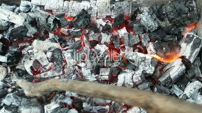 Breaking hot burnt charcoal