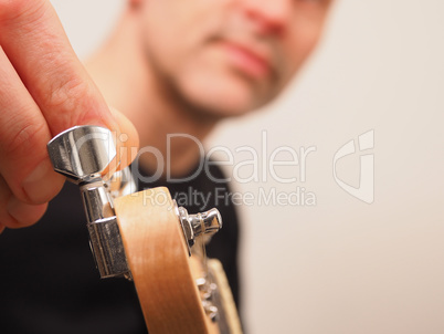 Musician tuning his electric guitar