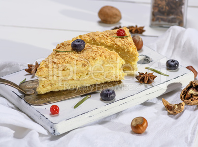 a piece of baked pie Napoleon with a cream