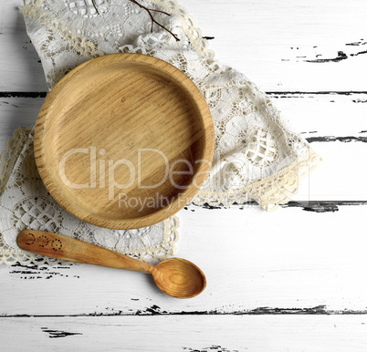 empty wooden round plate and wooden spoon