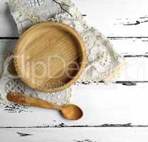 empty wooden round plate and wooden spoon