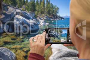 Woman Taking A Beautiful Lake Picture with Her Smart Phone