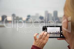 Woman Taking Pictures of The New Orleans Skyline with Her Smart