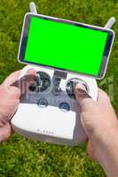 Hands Holding Drone Quadcopter Controller With Blank Green Scree