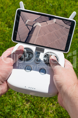 Hands Holding Drone Quadcopter Controller With Residential Roof