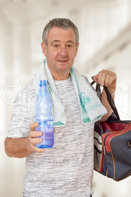 Man with water bottle and sports bag