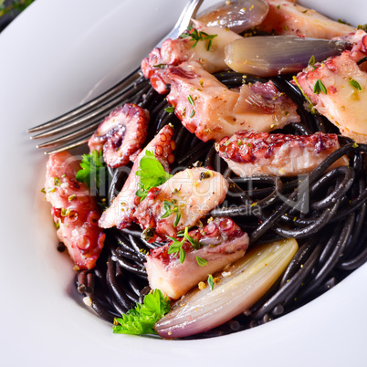 octopus with black spaghetti and garlic sauce